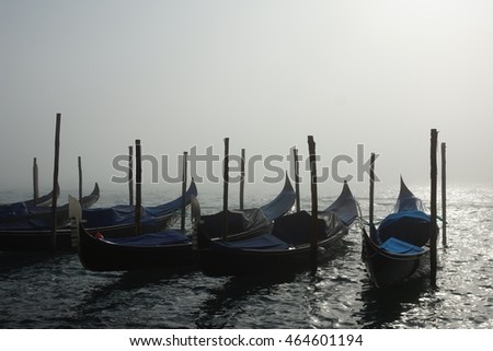 Gondolas moored in morning mist