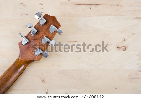 close up neck knob of Acoustic guitar on Wooden floor and space for writing.
