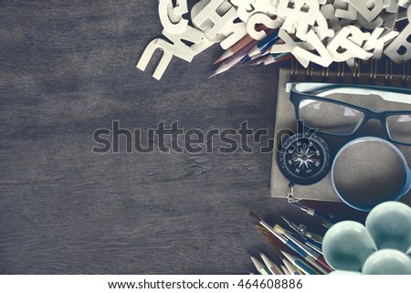 Dark vintage, top view set school supplies on a wooden table with copy space. Back to school