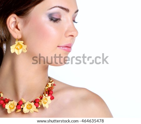Portrait of a beautiful woman with necklace, isolated on white background
