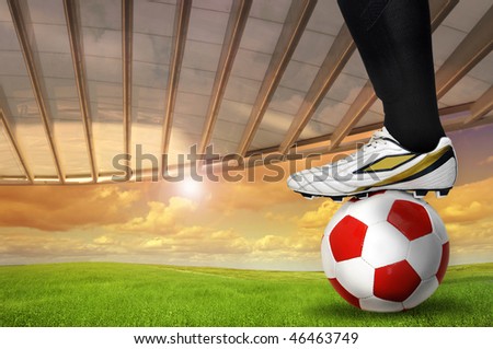 Soccer background with a players foot over a ball outdoors