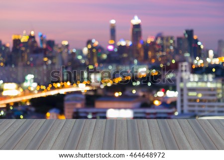 Opening wooden floor, Blurred city lights night view, multiple colours abstract background