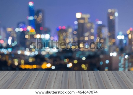 Opening wooden floor, City blur bokeh light during twilight