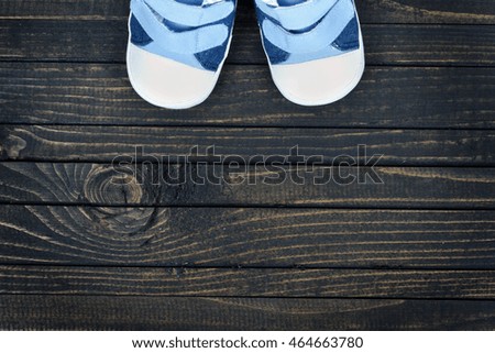 Kid shoes on wooden floor
