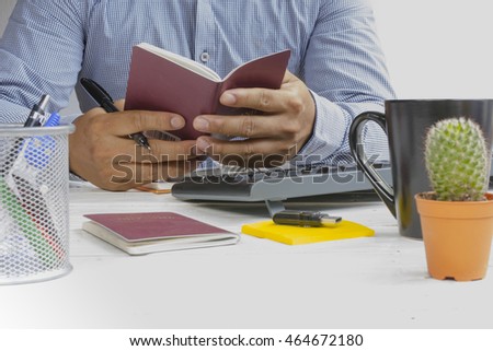 Man holding passport in his hand and traveling plan for relax in holiday.