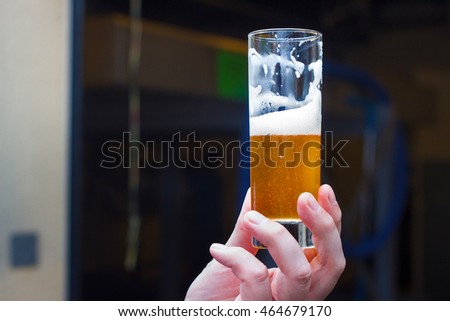 Belgian lambic (geuze) beer glass in hand. Royalty-Free Stock Photo #464679170