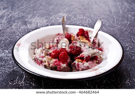 Ice cream with raspberries and waffles on a dark background. Selective focus.