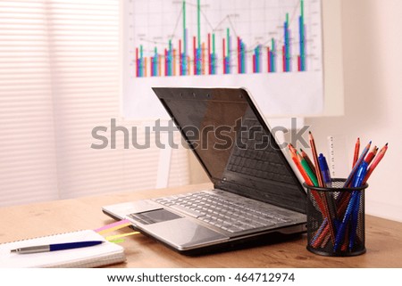 working desk with a computer and paperwork