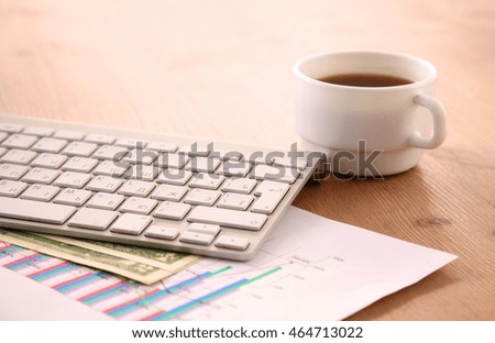 working desk with a computer and paperwork