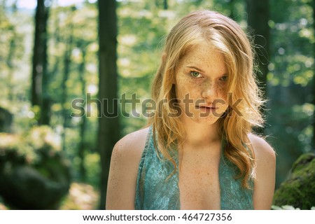 Freckles, red-haired woman  with green eyes