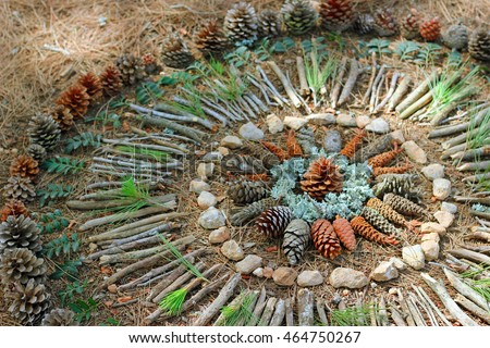Natural Mandala in the wood made of nature elements. Handmade outdoor art.