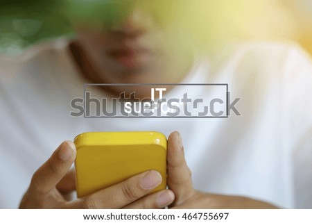 Woman using smartphone or mobile phone with IT SUPPORT text , business concept