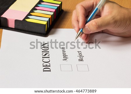 Business man hold blue pen for decision with colorful note