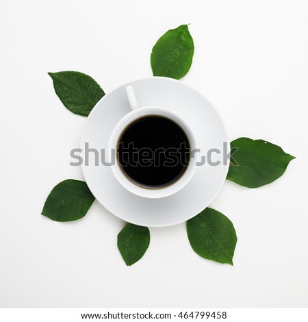 Flat lay. Top view. Coffee on white background with fresh leaves