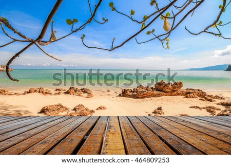 wooden plank under picture of beach with tree for relax