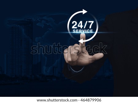 Businessman pressing button 24 hours service icon over map and city tower, Full time service concept, Elements of this image furnished by NASA
