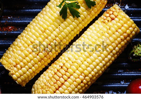 Mexican food, corn on the grill with spices, dark background, top view