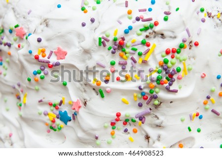 icing on the cake. colorful donuts glaze pattern with sprinkle topping on a white cream background. Abstract food bakery decoration texture.