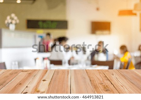 Look out from the table, blur image of inside coffee shop as background.(On vintage tone)