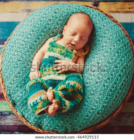 amazing  baby sleeping on a green cushion