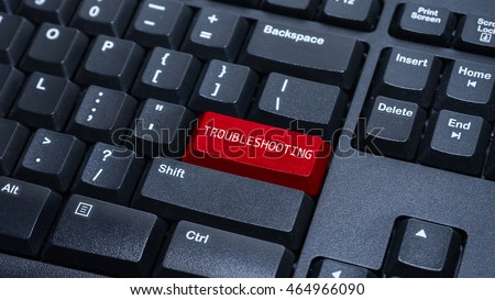 Close up on customized computer enter button on keyboard with a word troubleshooting. Royalty-Free Stock Photo #464966090