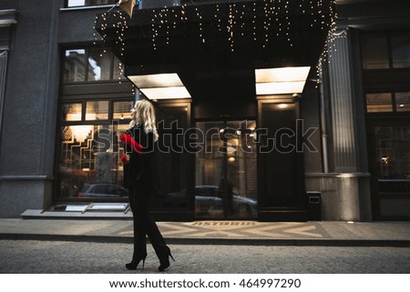 young woman walking down the street near the hotel