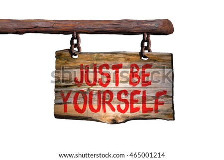Just be yourself motivational phrase sign on old wood with blurred background