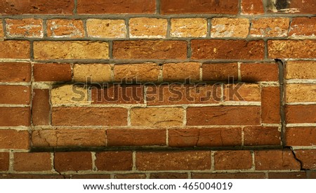 An old brick wall with signs of aging