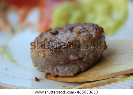 Small piece of fresh grilled meat, meat raclette