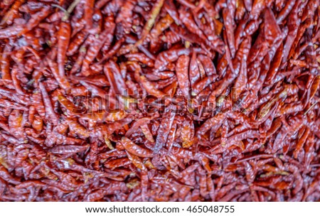Blur picture of pile of dry red peppers displayed at the local farmer market