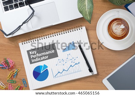 KPI acronym (Key Performance Indicator) Tablet with blank black screen and coffee cup Royalty-Free Stock Photo #465065156
