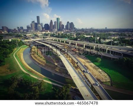 Aerial view downtown and interstate I45 highway with massive intersection, stack interchange, junction and elevated road construction at sunset from northwest side of Houston, Texas, USA. Vintage look