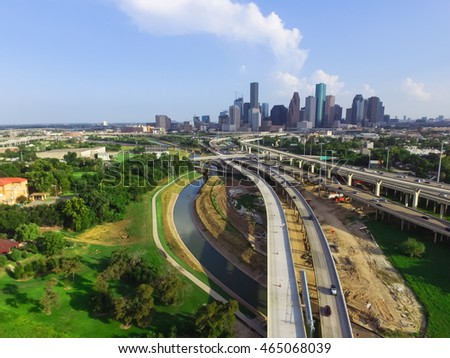 Aerial view downtown and interstate I45 highway with massive intersection, stack interchange, road junction overpass and elevated road construction at sunset from northwest side of Houston, Texas, USA