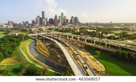 Panorama aerial view downtown and interstate I45 highway with massive intersection, stack interchange, road junction and elevated road construction at sunset from northwest side of Houston, Texas, USA