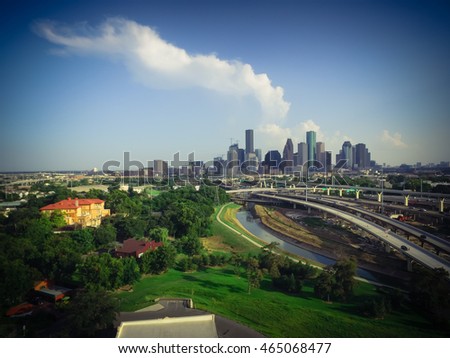 Aerial view downtown and interstate I45 highway with massive intersection, stack interchange, junction and elevated road construction at sunset from northwest side of Houston, Texas, USA. Vintage look