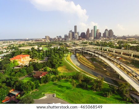 Aerial view downtown and interstate I45 highway with massive intersection, stack interchange, road junction overpass and elevated road construction at sunset from northwest side of Houston, Texas, USA