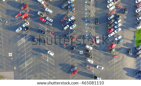 Panorama top view parking lots with rows of parked car, shopping carts, road sign for disabled drivers at a supermarket in Houston, Texas, USA at sunset.Urban infrastructure and transportation concept