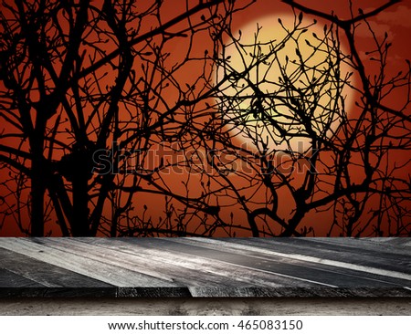 Empty grunge plank wooden table top at spooky tree and full moon with dead tree,Halloween holiday concept,Template mock up for display or montage of product.