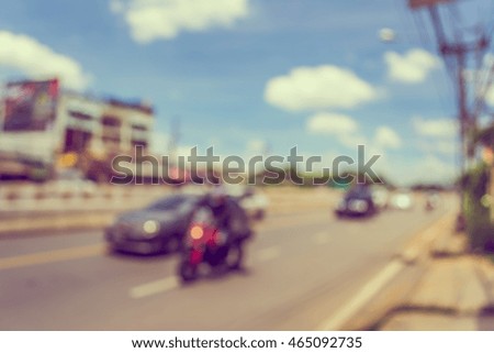 abstract blur of the road with car on day time for background usage. (vintage tone)