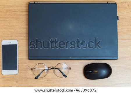 Flat lay object laptop with glasses and cellphone on old wooden table