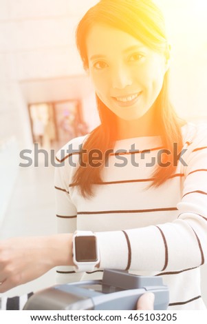 Woman using smart watch to pay