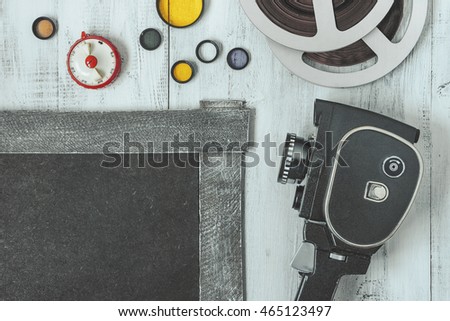 Old movie camera and accessories are painted on a white board.View from above.