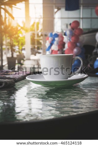 Coffee cup in Car Showroom,vintage style effect picture