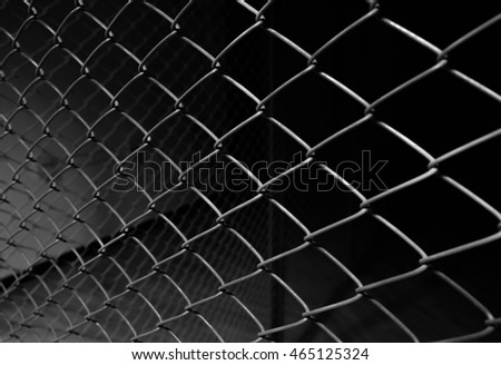 Metal wire fence or cage with blur background. Abstract background Royalty-Free Stock Photo #465125324