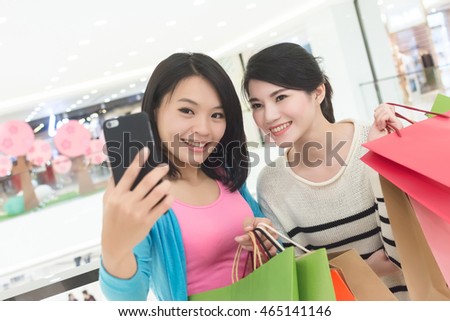 Excite women go shopping and take a selfie in department store