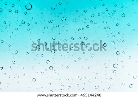 Water drops background. Water drops on glass window over blue sky