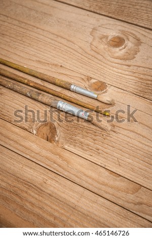 paint brushes on a wooden background