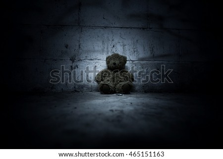 Teddy bear sitting in haunted house,Scary background for book cover