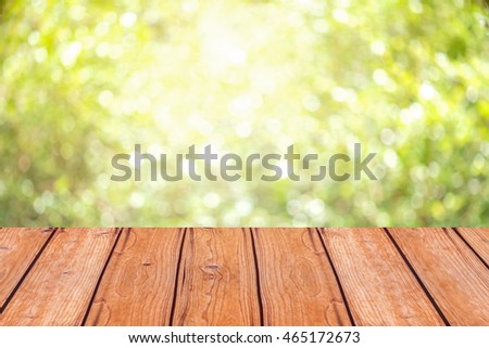 wooden table with space for your photo montage and green color of background