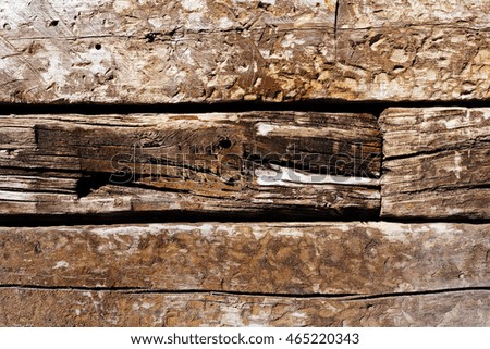 crude wooden planks like a wall, note shallow depth of field
